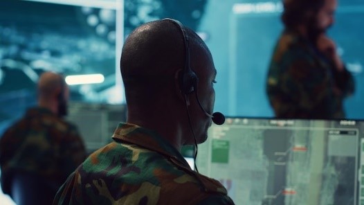 Soldier with headset in control room